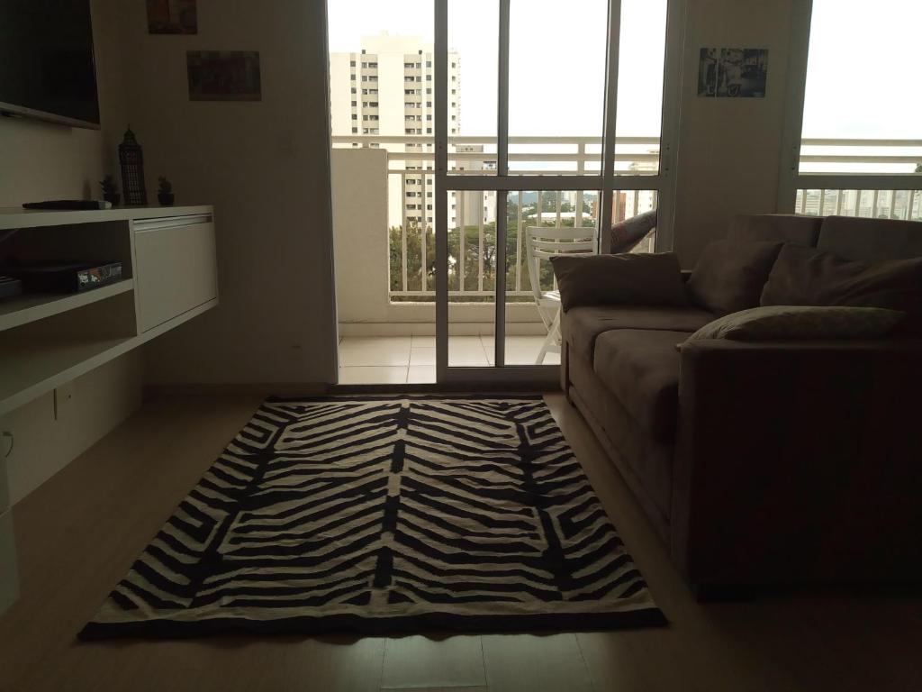 um tapete de zebra numa sala de estar com um sofá em Conforto no Alto da Boa Vista em São Paulo