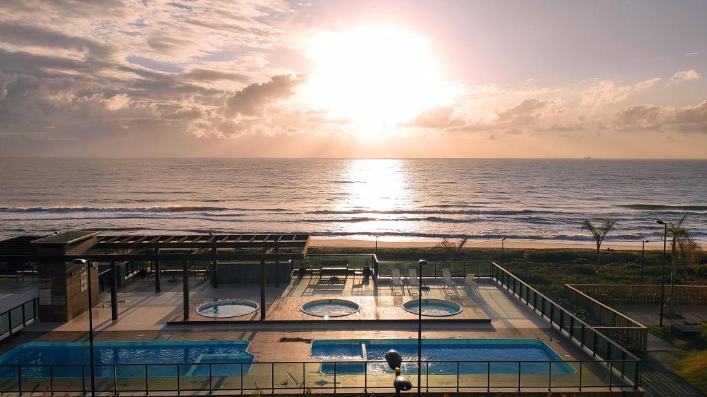 a view of the ocean from a resort with two pools at Paraíso Frente ao Mar in Barra Velha