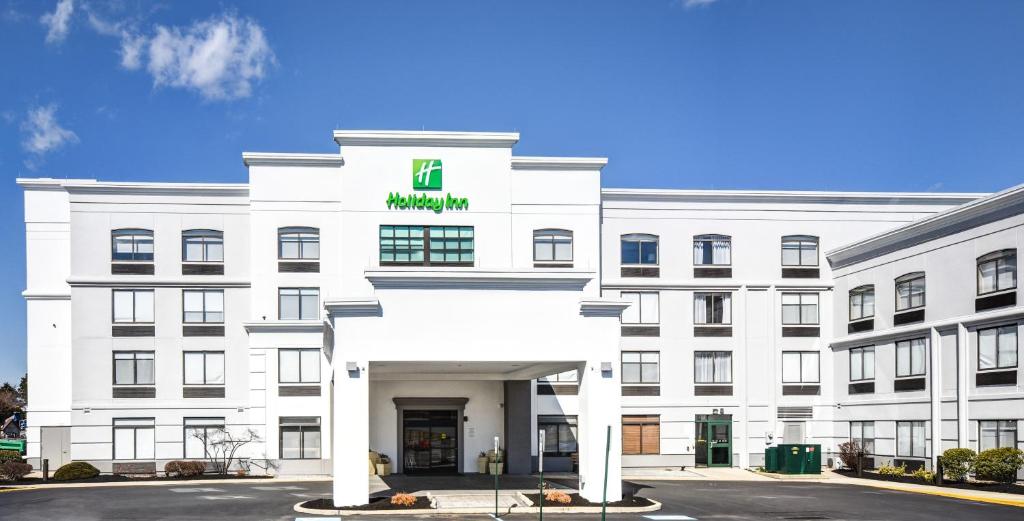 a white building with a green sign on it at Holiday Inn Allentown-Bethlehem, an IHG Hotel in Allentown