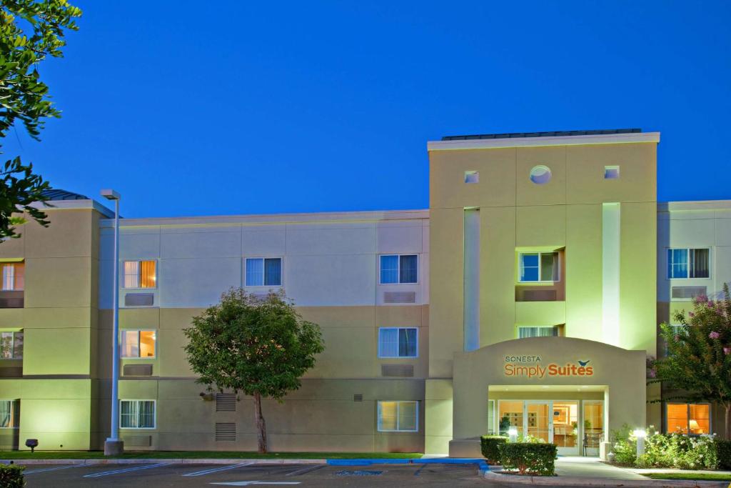 a building with a sign on the front of it at Sonesta Simply Suites Irvine Spectrum in Irvine