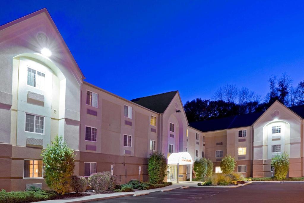 a row of apartment buildings at night at Sonesta Simply Suites Parsippany Morris Plains in Morris Plains