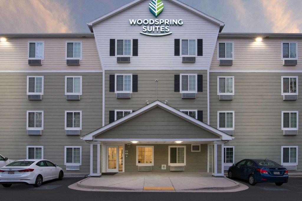 a woodworking services building with cars parked in front of it at WoodSpring Suites Savannah Garden City in Savannah