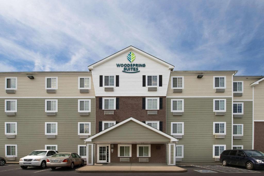 un gran edificio con un cartel en la parte superior en WoodSpring Suites Murfreesboro, en Murfreesboro