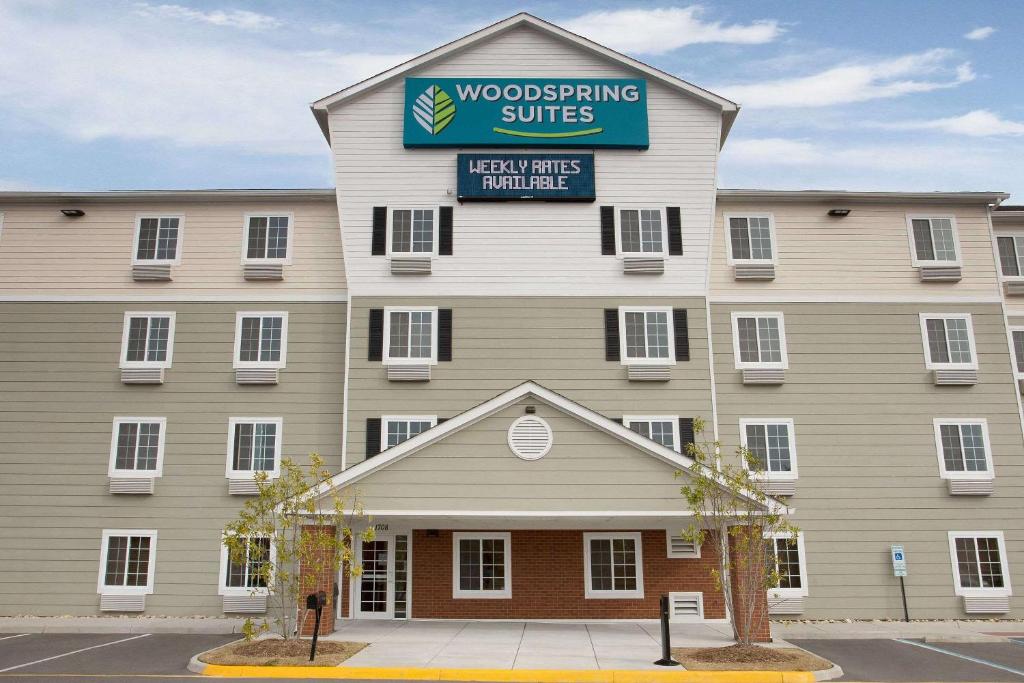 a building with a sign that reads woodworking suites at WoodSpring Suites Chesapeake-Norfolk Greenbrier in Chesapeake