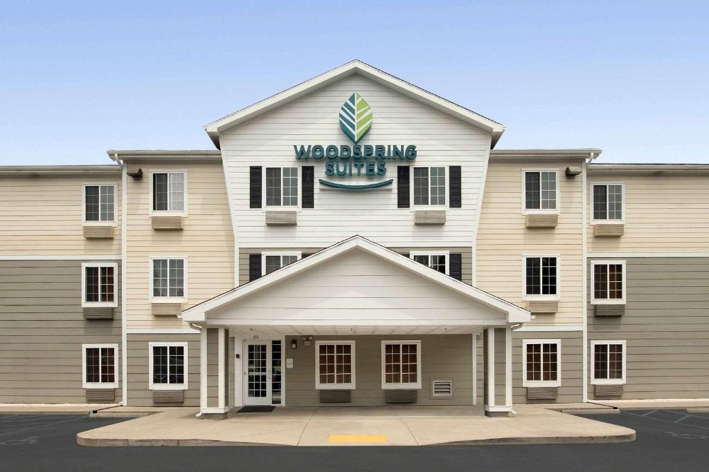 a building with a sign on top of it at WoodSpring Suites Spartanburg Duncan in Duncan