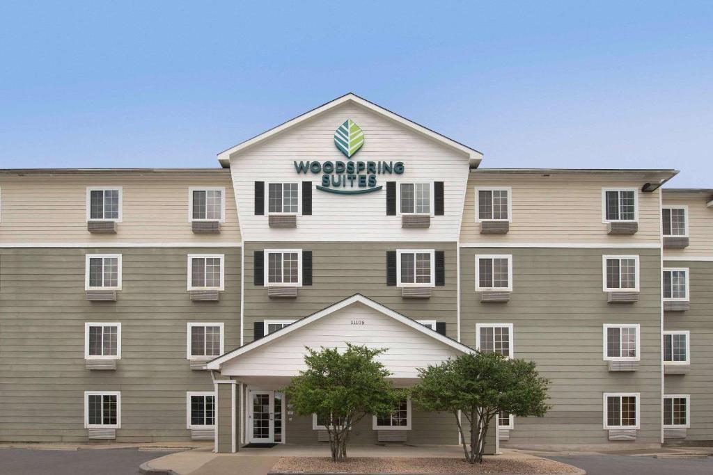 a building with a sign on the front of it at WoodSpring Suites Austin North I-35 in Austin