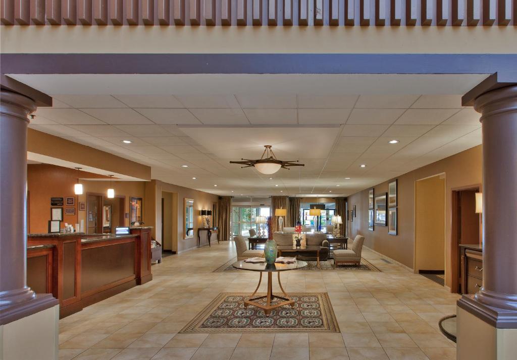 a lobby of a hospital with a table and chairs at The Rockville Hotel, a Ramada by Wyndham in Rockville