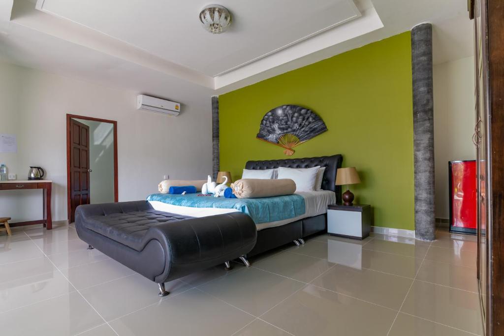 a bedroom with a large bed and a large window at Yao Yai Beach Resort in Ko Yao Yai
