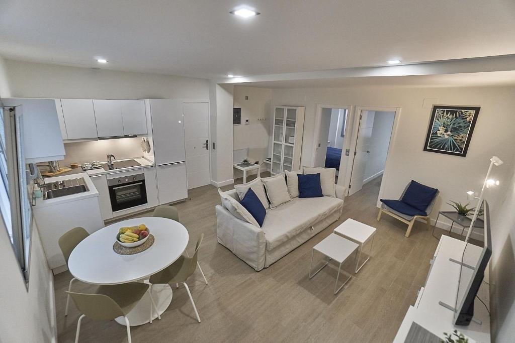 a living room with a couch and a table at Malibú Canteras nº 1 - Planta Baja - Ground Floor in Las Palmas de Gran Canaria