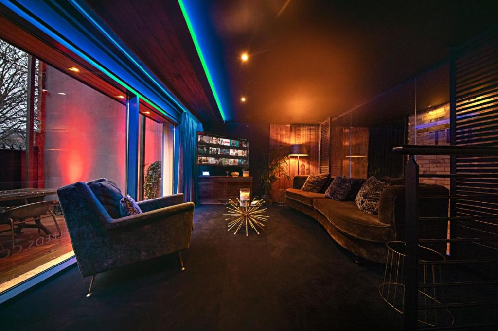 a living room with a couch and chairs and lights at The Bells - Luxury Serviced Apartments in Leeds