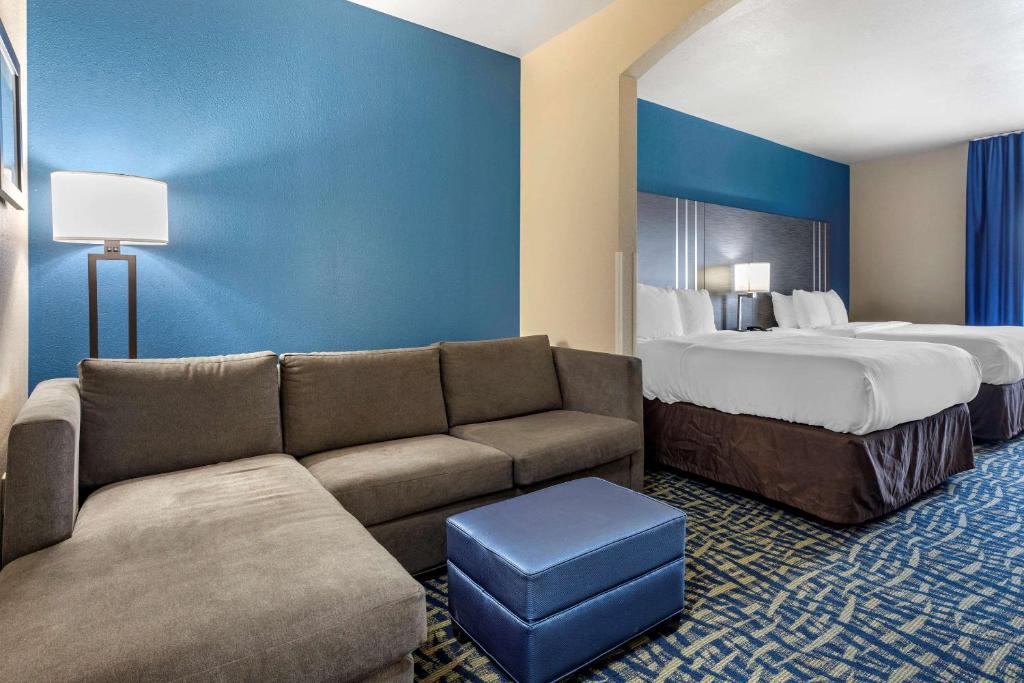 a hotel room with a couch and a bed at Comfort Inn & Suites Pauls Valley - City Lake in Pauls Valley