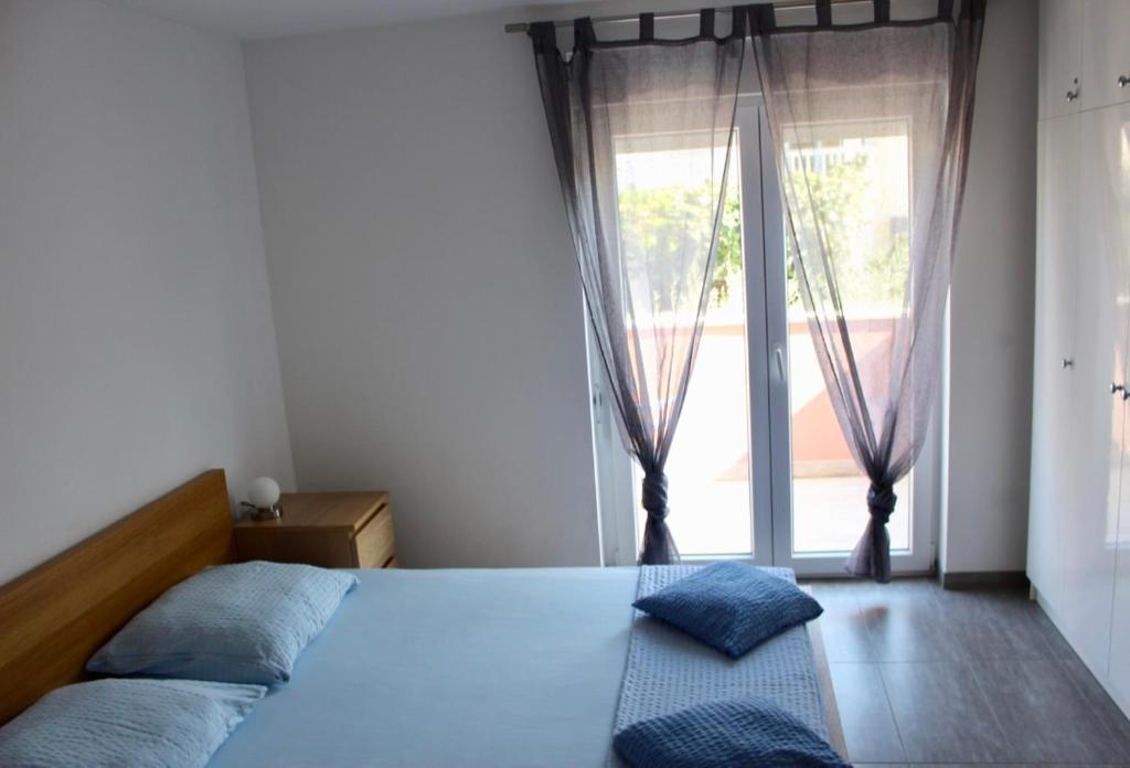 Postel nebo postele na pokoji v ubytování Filipovic Apartmani