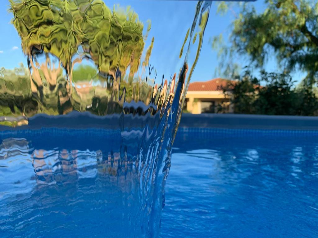 a glass vase sitting next to a swimming pool at Exlusive Pool Villa - Cascina Relais in Comiso