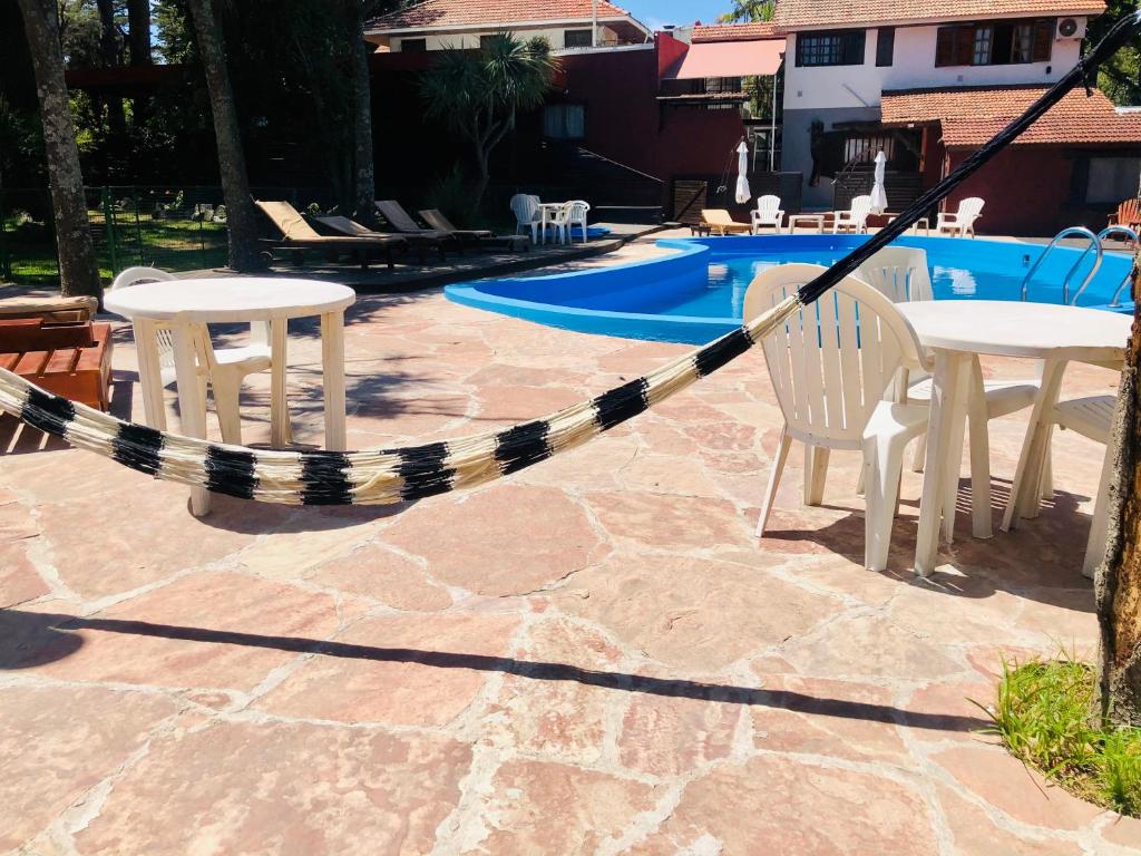 a rope around a table and chairs next to a pool at Hotel Villa Santa Maiani in Mar del Plata