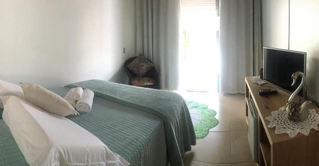 Cama ou camas em um quarto em Pousada Ilha do Mel