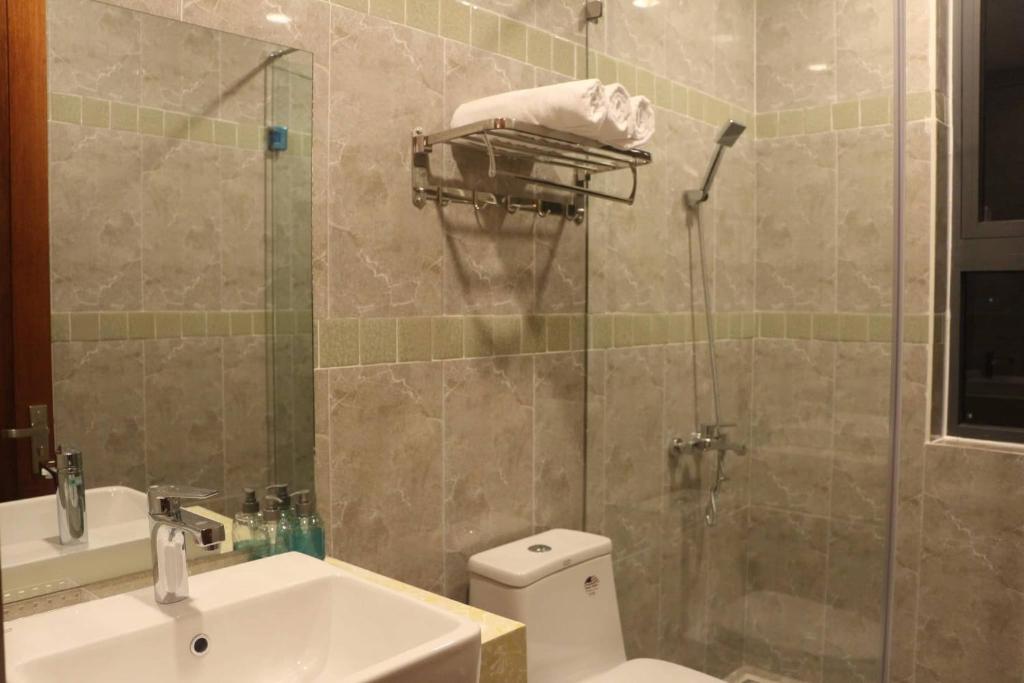 a bathroom with a shower and a toilet and a sink at Hostel Khanh Hương 2 in Da Lat