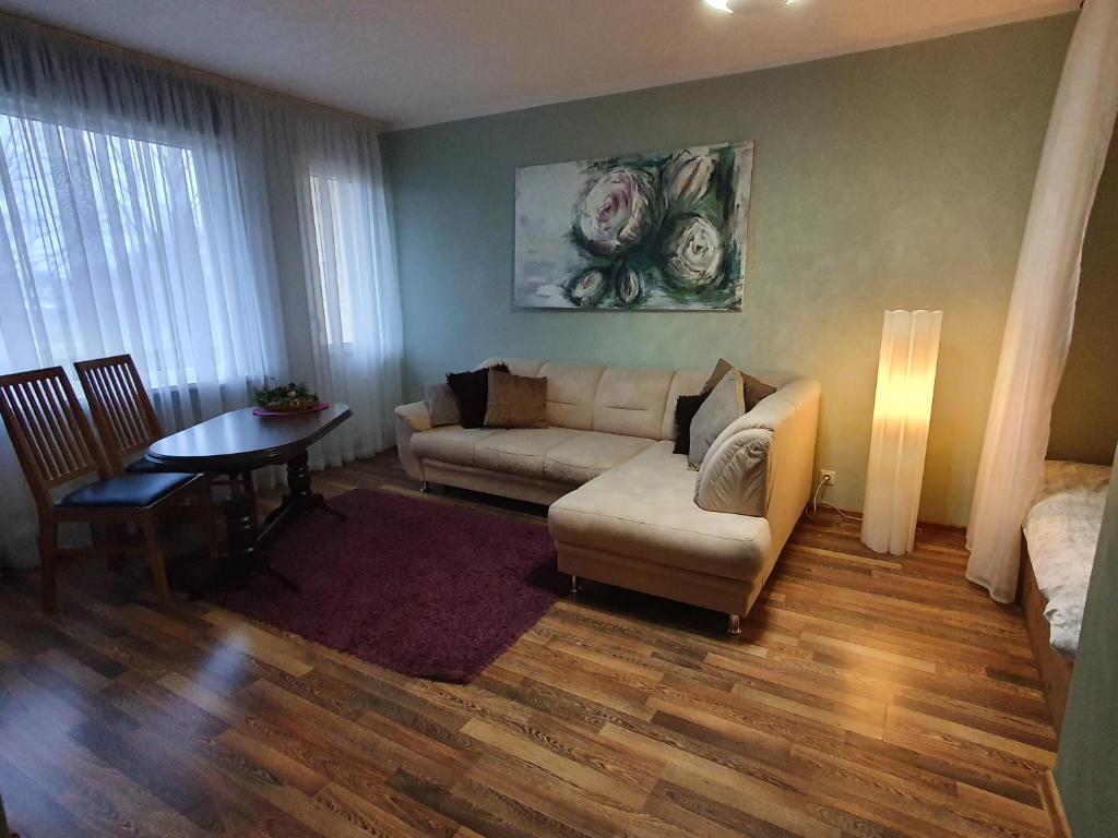 a living room with a couch and a table at Shokolade in Ventspils
