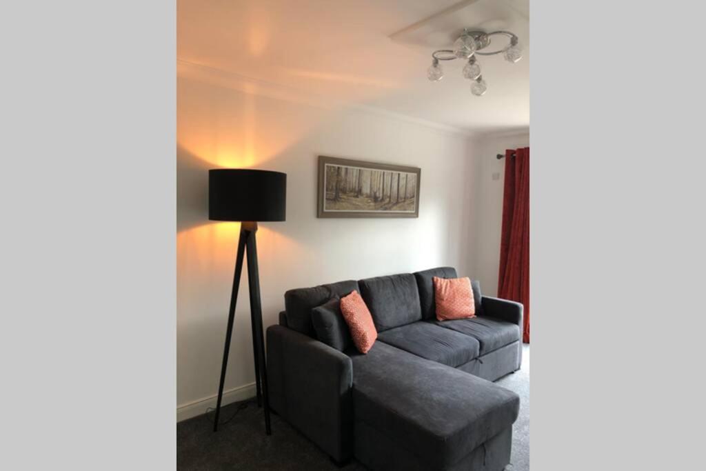 a living room with a couch and a lamp at The Annex at Bonnieview in Inverness