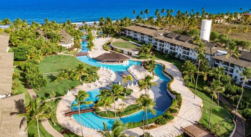 an aerial view of a resort with two swimming pools at Flat Beach Class Resort Muro Alto in Porto De Galinhas