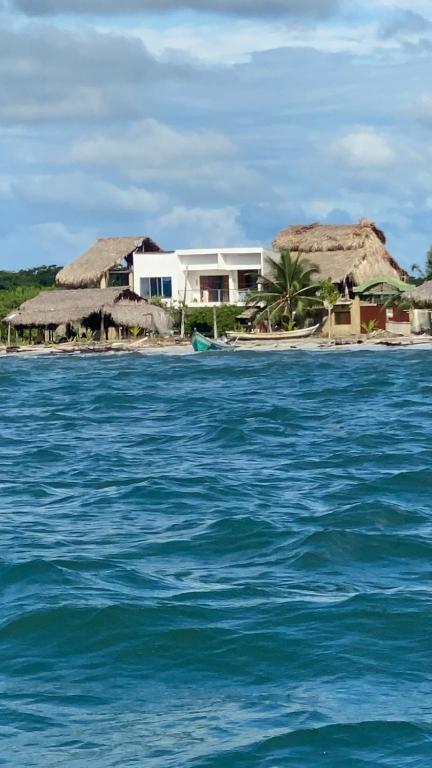 a house on an island in the middle of the ocean at Luna Roja casa Frente al Mar y glamping in San Onofre