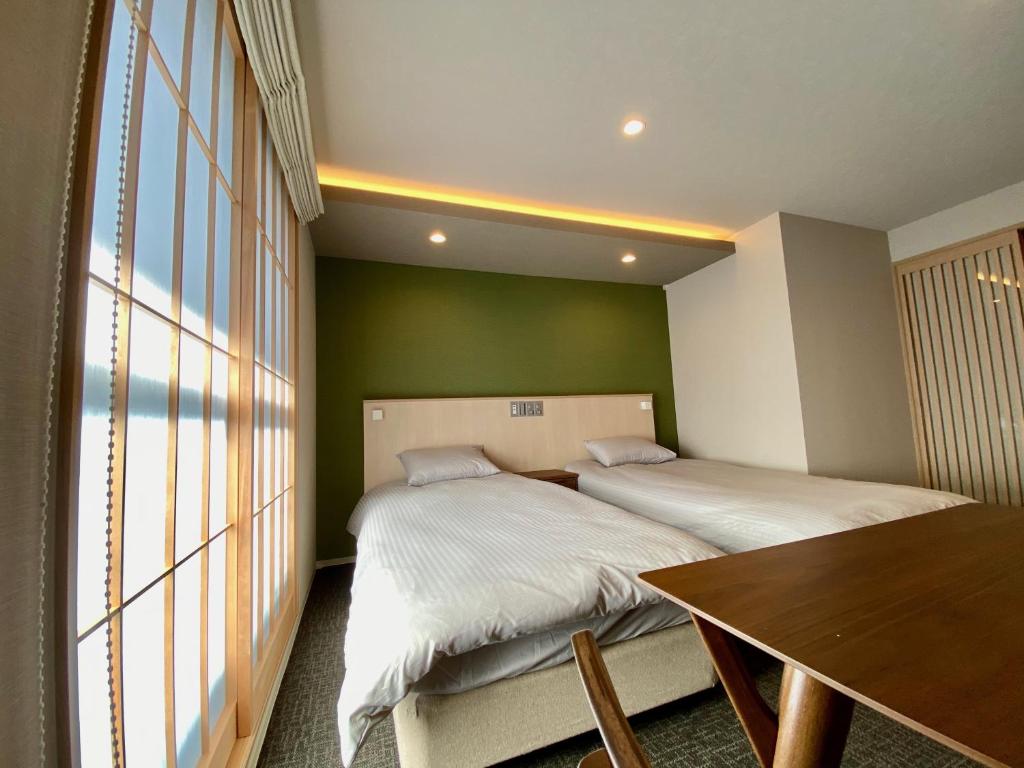 Postel nebo postele na pokoji v ubytování HIZ HOTEL Gion-Shirakawa