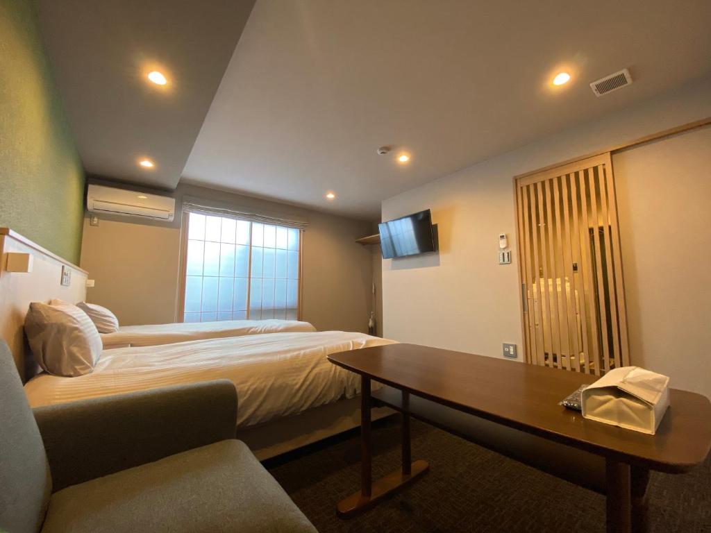 Postel nebo postele na pokoji v ubytování HIZ HOTEL Gion-Shirakawa
