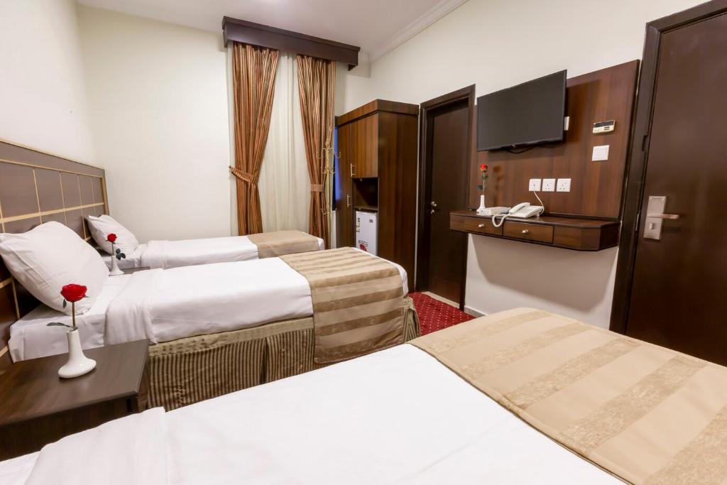 เตียงในห้องที่ Yasmin Al Majd Hotel