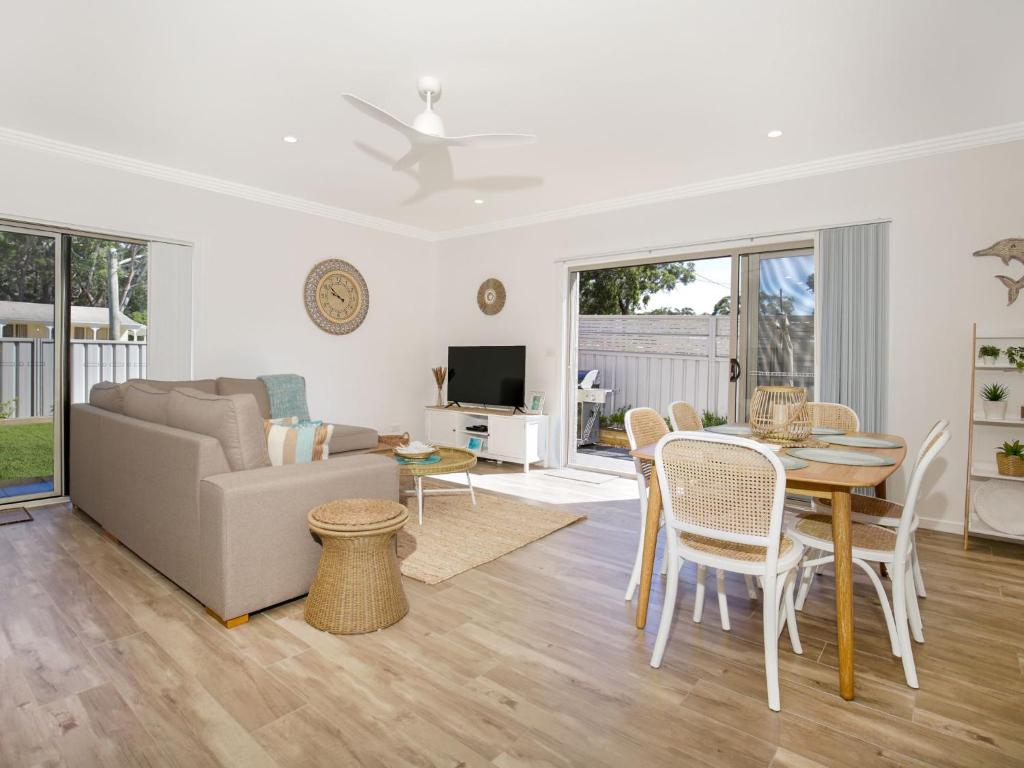 a living room with a table and a couch at Salty Shores Jervis Bay I 3 Mins to Beach in Callala Beach