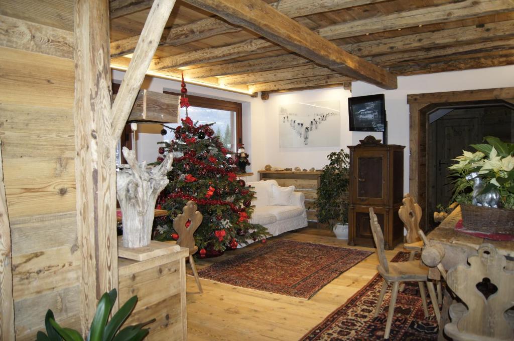 a living room with a christmas tree in it at Hotel da Beppe Sello in Cortina dʼAmpezzo