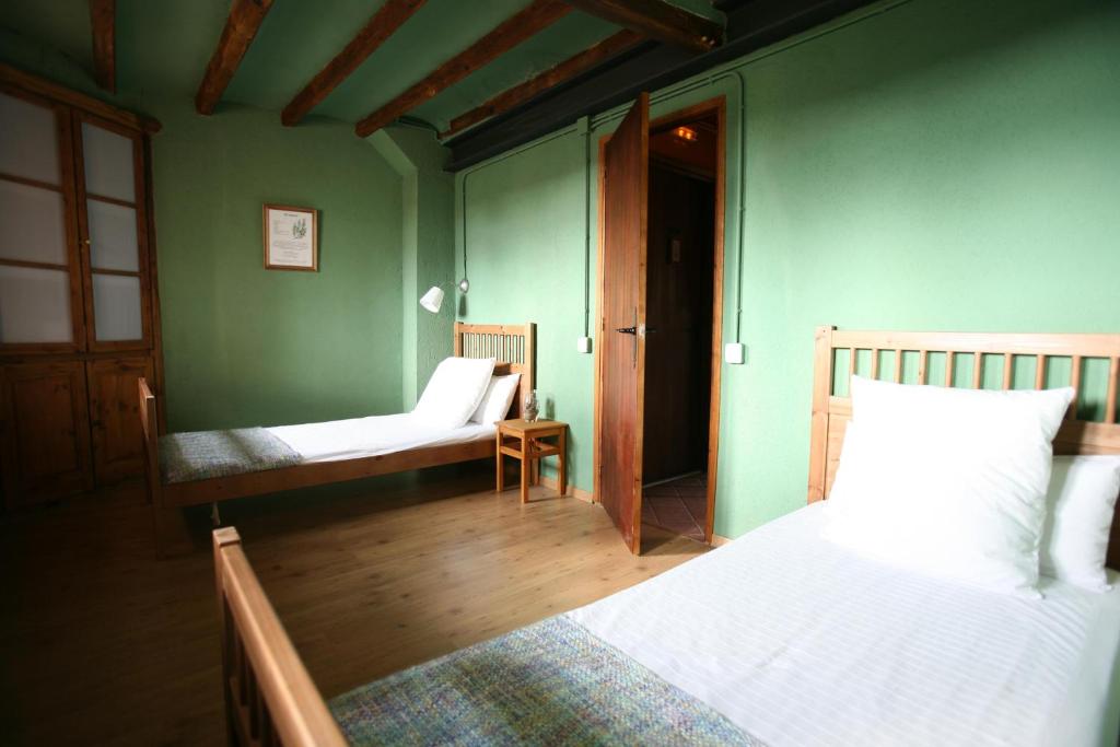 a room with two beds and a door to a bedroom at Cal Ferrer Nou in Alpens