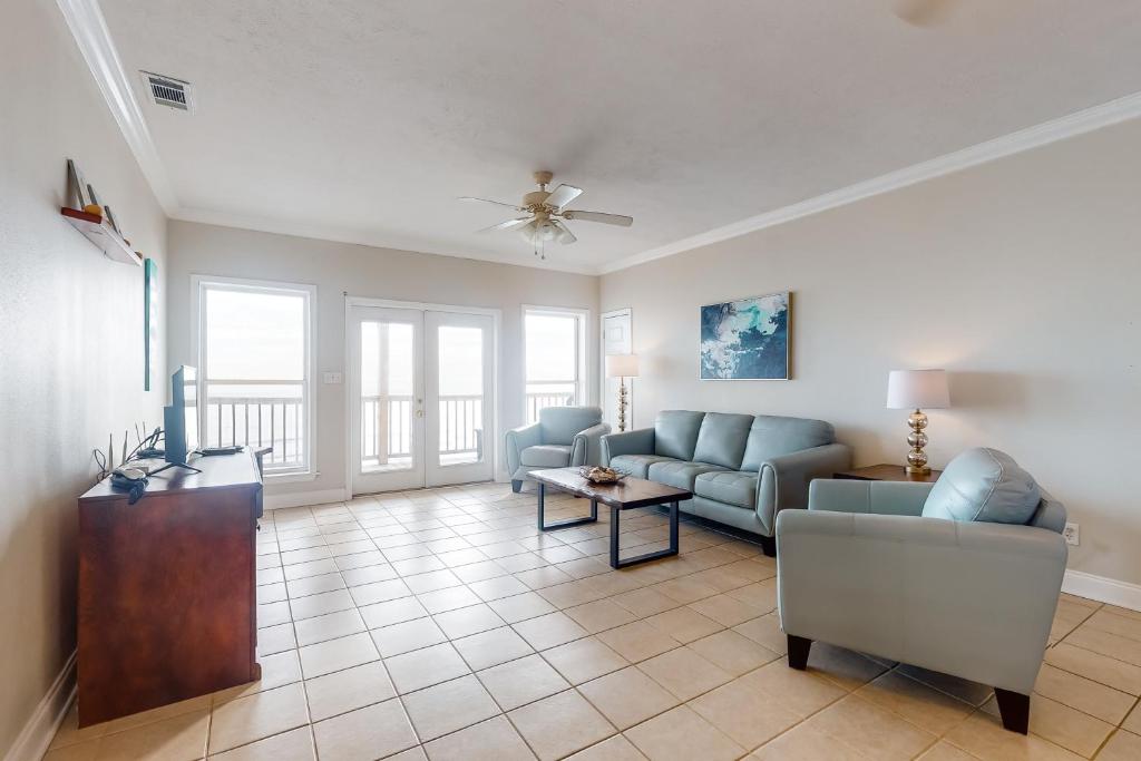 a living room with a couch and a table at Midsummer Solstice in Dauphin Island