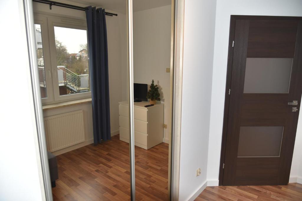 una camera con una porta scorrevole in vetro e una finestra di Apartament Jantar z ogrodem a Kołobrzeg
