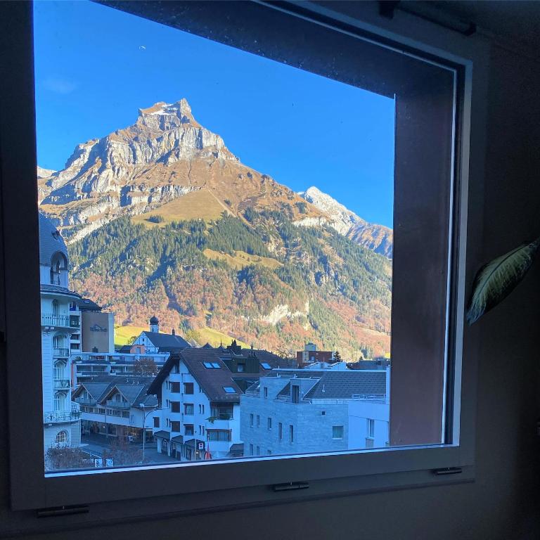 a view of a mountain from a window at Hotel Central in Engelberg
