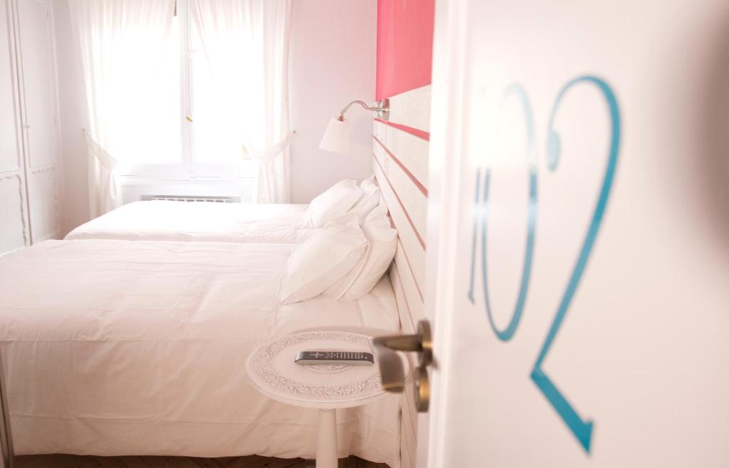 Posteľ alebo postele v izbe v ubytovaní Hostal Boreal Mistral