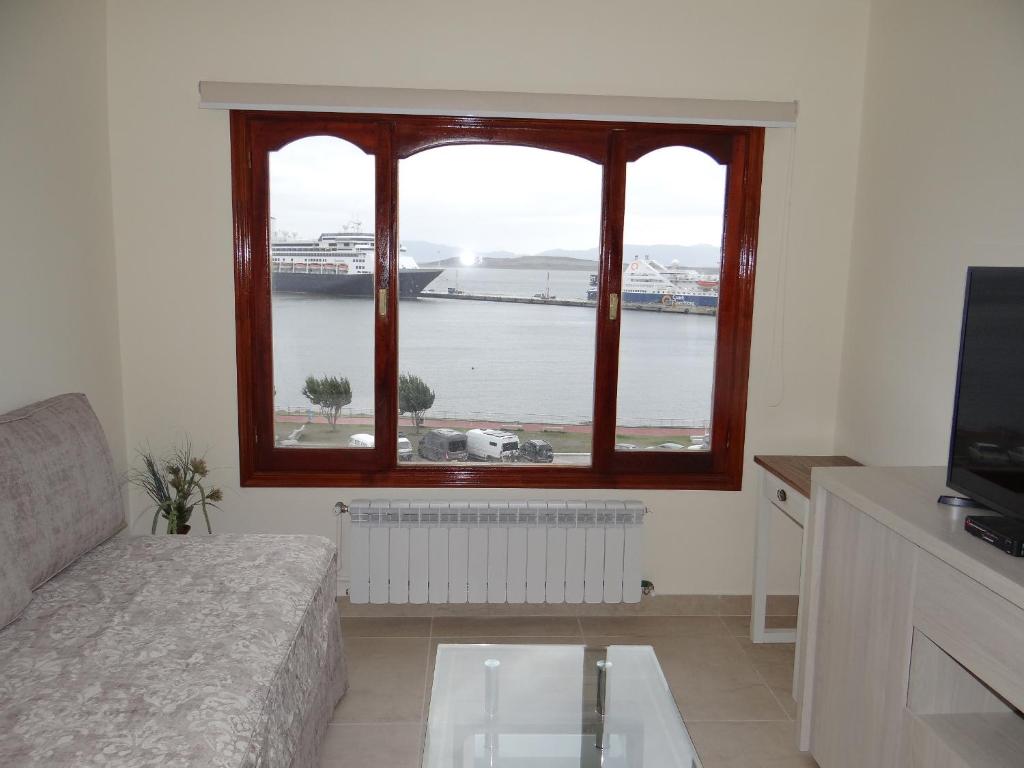 a living room with a window with a view of a harbor at Mirando al Sur in Ushuaia