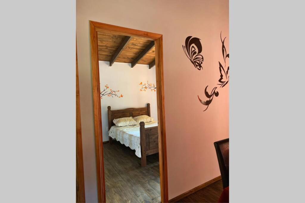 a mirror in a room with a bed and a bedroom at Cabaña Campestre Miramar in Playa Verde