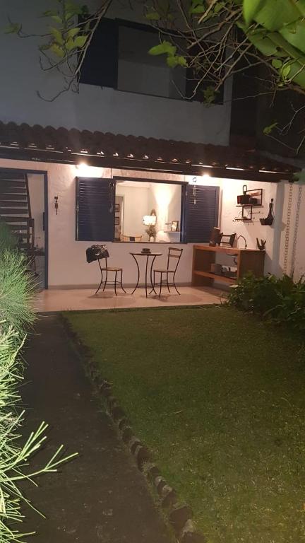 a house with a patio with a table and chairs at Casa Boutique Peró in Cabo Frio