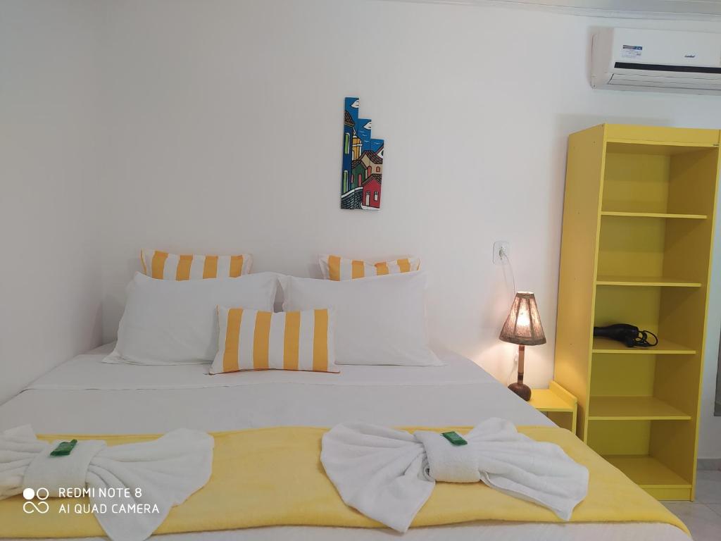 a bedroom with a bed with two towels on it at Pousada João Maria in Trancoso