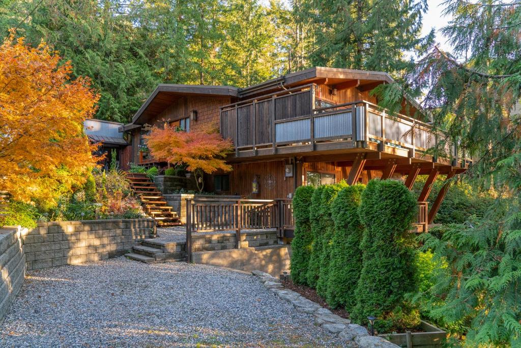 a house with a staircase leading up to it at Coastal Fox Den in Sechelt