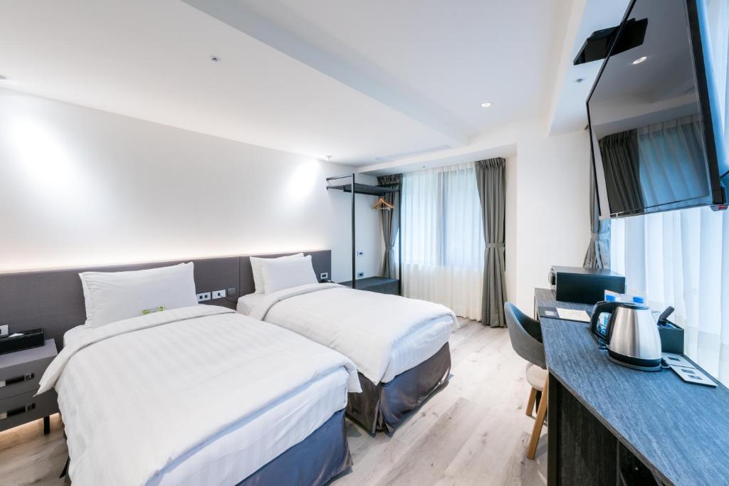 Postel nebo postele na pokoji v ubytování RF Hotel - Zhongxiao
