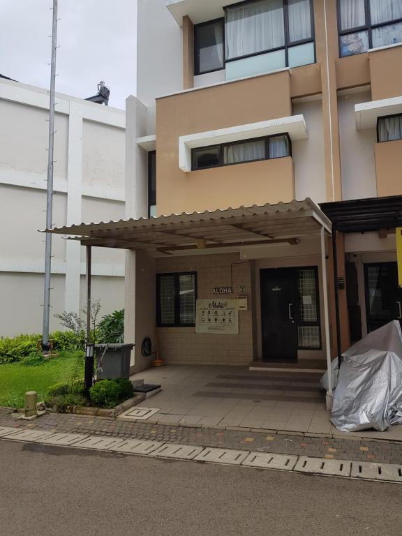 a building with awning in front of a building at Aloha Guest House 2 - Female Only in Tangerang