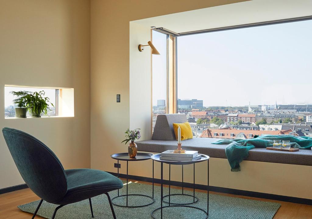 a living room with a couch and a large window at Charlottehaven in Copenhagen