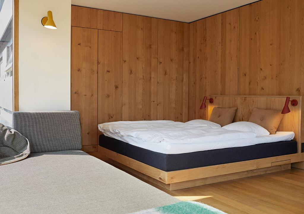 a bedroom with a bed in a wooden wall at Charlottehaven in Copenhagen