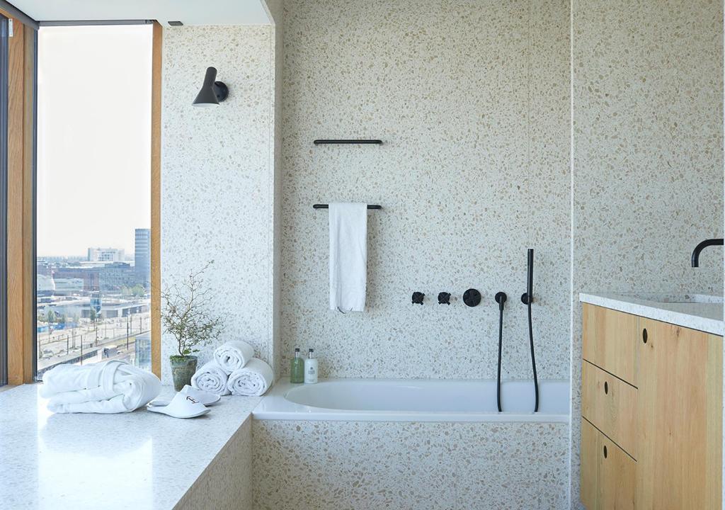 a bathroom with a tub and a sink at Charlottehaven in Copenhagen