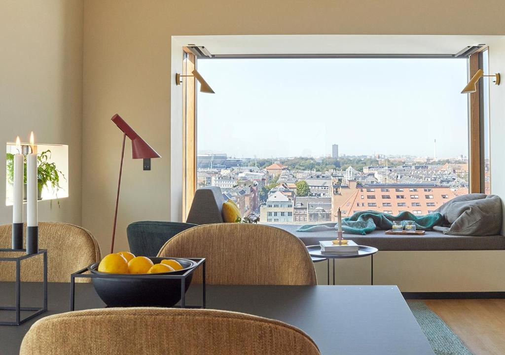 a room with a table with a bowl of fruit on it at Charlottehaven in Copenhagen