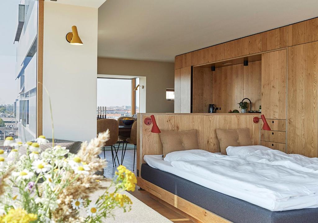 a bedroom with a bed with a wooden headboard at Charlottehaven in Copenhagen