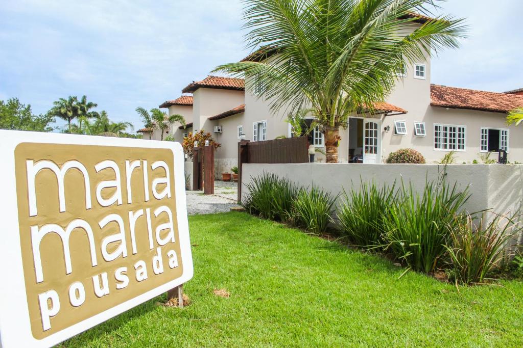 a real estate sign in front of a house at Pousada Maria Maria Búzios in Búzios