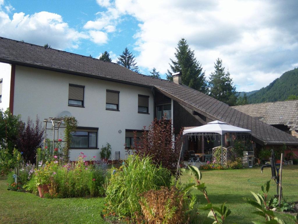 a white house with a gazebo in a yard at Haus Tapestry in Nötsch