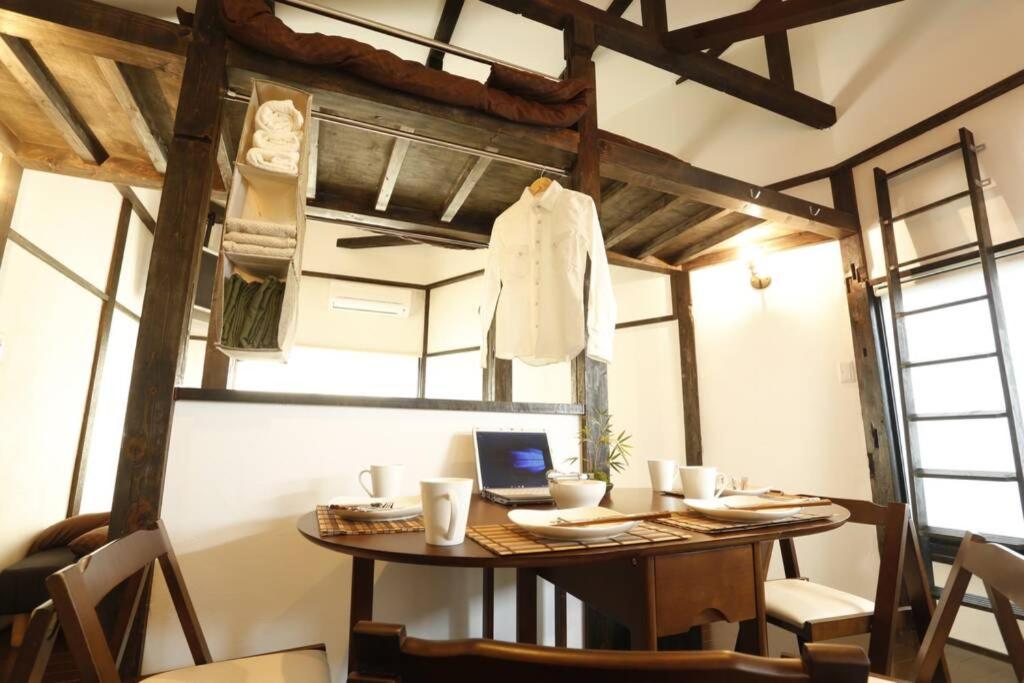 a room with a table with a laptop on it at アンドステイ西早稲田3丁目B in Tokyo