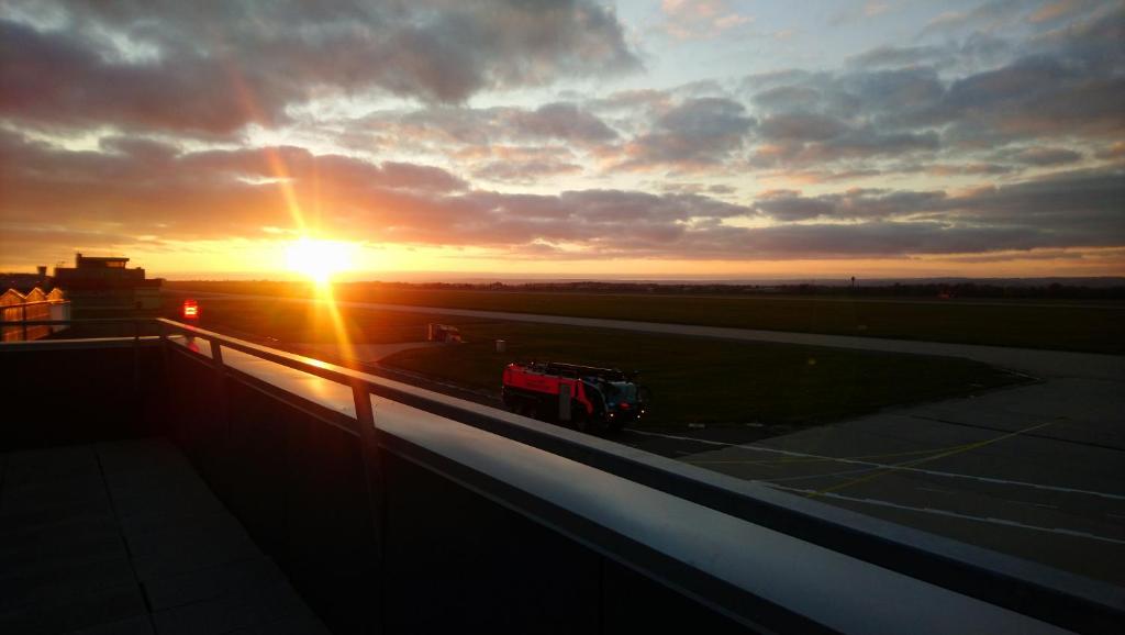a truck on a runway with the sunset in the background at Elmontex Air in Mošnov